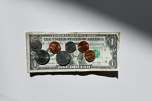 Paper money and coins on a white surface