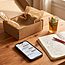 Online customer support workspace with smartphone and prepared parcel