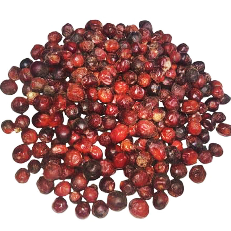Loose red-brown whole doum fruits on a white background