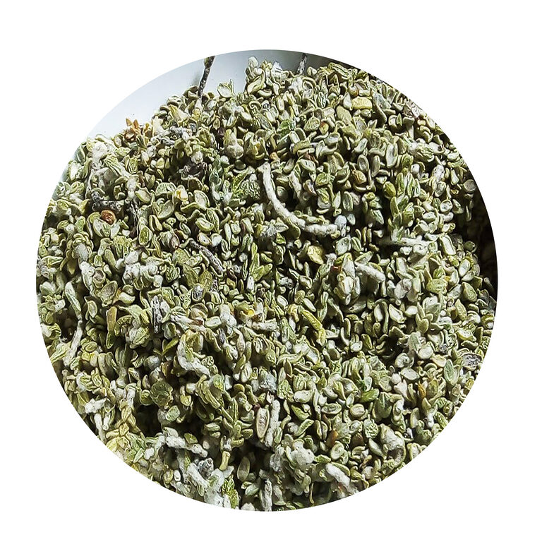 Close-up of loose dried sage-green Metnane leaves mixed with pale woolly shoots, shown in a round frame on a white background