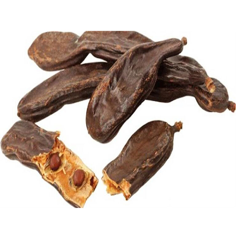 Whole dark-brown dried carob pods, including opened pods showing brown seeds, on a white background