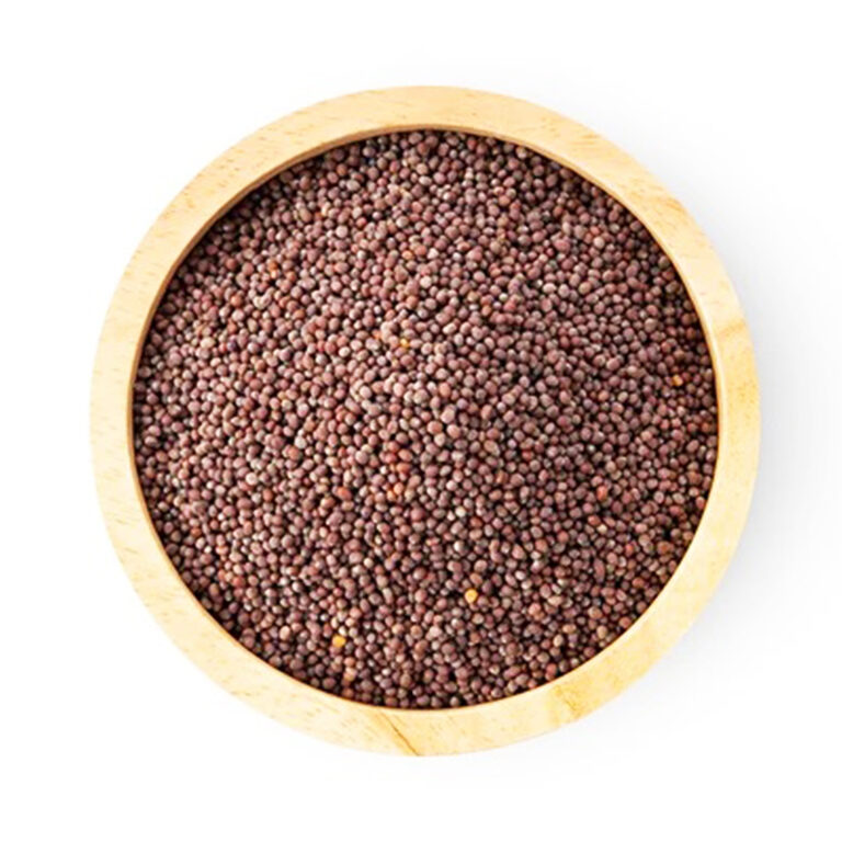 Top view of small round reddish-brown mustard seeds filling a light wooden bowl on a white background