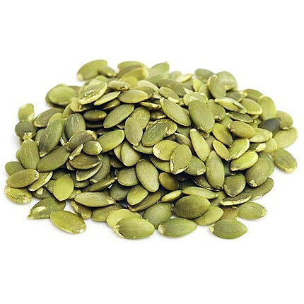 A heap of flat, oval green hulled pumpkin seeds in olive and pale green shades, on a white background