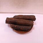 Three thick dark dried Ood Saleeb root pieces arranged on a small brown dish