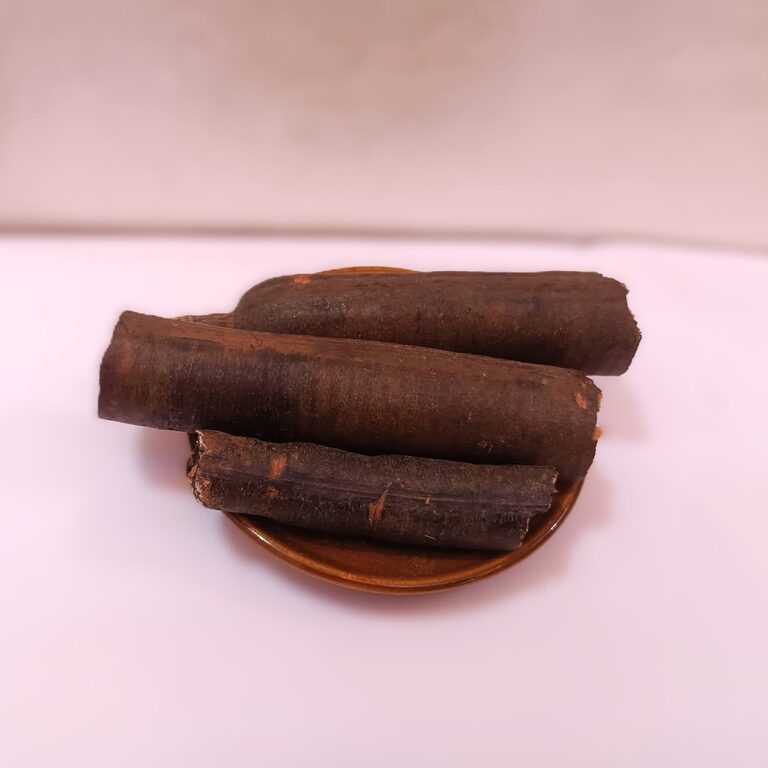 Three thick dark dried Ood Saleeb root pieces arranged on a small brown dish