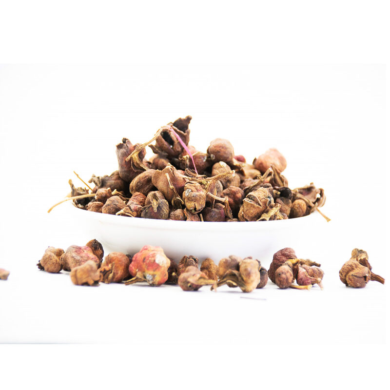 Loose dried Aik buds piled in a white bowl on a white background