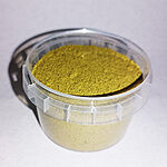 Open clear plastic tub holding fine green-gold herbal powder for hair.