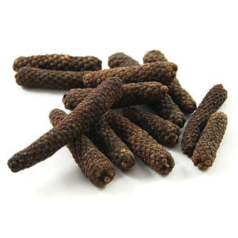 A loose pile of whole dried long pepper spikes, dark brown with a knobbly surface, on a white background