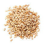 A heap of whole light golden-beige sesame seeds with a few loose seeds scattered on a white background