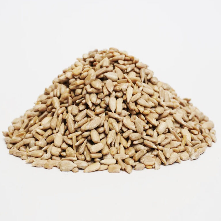 Heap of pale hulled sunflower kernels on a plain white background