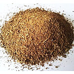 A loose mound of coarse tan-brown Indian costus root powder spread across a plain white surface.