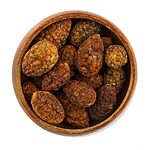 Whole wrinkled dried caper buds in a small wooden bowl on a white background