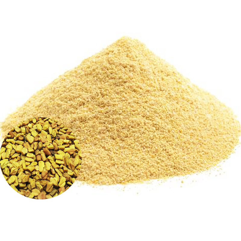 Mound of pale golden fenugreek powder with an inset of whole fenugreek seeds on a white background