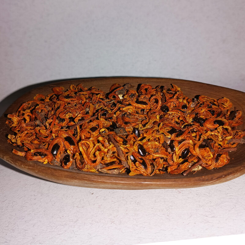 Wooden dish filled with orange, brown and black loose Zaghbat Alou incense pieces.