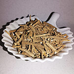 Light-brown dried ashwagandha root pieces in a white dish