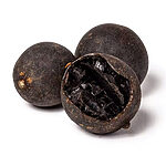Three whole dark dried black lemons, with one cut open to show its dark interior