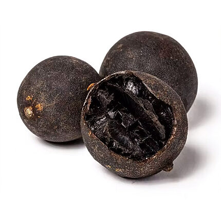 Three whole dark dried black lemons, with one cut open to show its dark interior