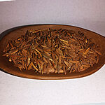 Loose brown fibrous Lissan Ettir dried herb in a wooden dish
