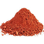 Loose mound of finely ground terracotta-red clay powder on a white background