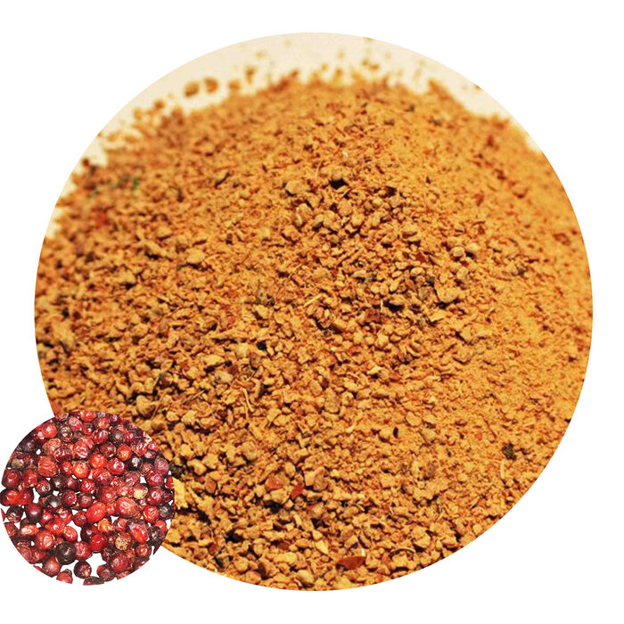 Coarse golden-brown doum powder in a round close-up with whole fruits inset
