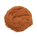 Close-up of a mound of fine reddish-brown Peganum harmala powder on a white background.